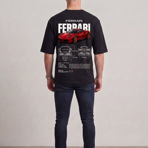 A man viewed from behind wearing a black short-sleeve t-shirt with a large red Ferrari sports car graphic and white 'FERRARI' text on the back, paired with dark blue jeans and white sneakers, against a neutral studio background l AH Urban Wear