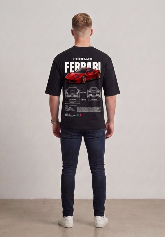 A man viewed from behind wearing a black short-sleeve t-shirt with a large red Ferrari sports car graphic and white 'FERRARI' text on the back, paired with dark blue jeans and white sneakers, against a neutral studio background l AH Urban Wear
