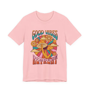 Women light pink short-sleeve t-shirt with a retro 70s-style graphic on the front featuring a mushroom, flowers, a snake, and the words 'GOOD VIBES RETREAT' | AH Urban Wear PK