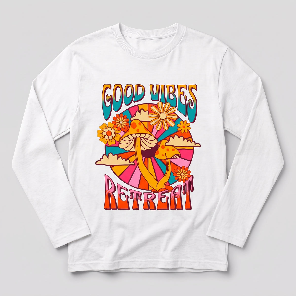 A white long-sleeve t-shirt with a colorful retro 70s-style graphic on the chest that reads 'GOOD VIBES RETREAT' with mushrooms, flowers, and abstract shapes, shown on a light gray background l AH Urban Wear