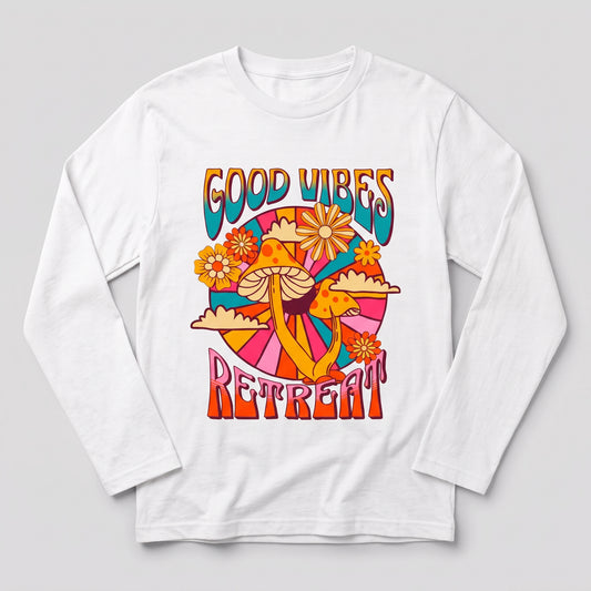 A white long-sleeve t-shirt with a colorful retro 70s-style graphic on the chest that reads 'GOOD VIBES RETREAT' with mushrooms, flowers, and abstract shapes, shown on a light gray background l AH Urban Wear