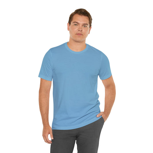 A man wearing a plain light blue crew-neck t-shirt and dark gray pants, standing against a solid white background | AH Urban Wear PK