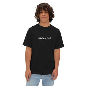 Person wearing a black drop shoulder t-text written "freak out" on a shirt on a white background l AH Urban Wear