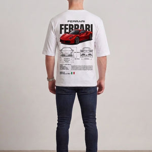 A man viewed from behind wearing a white drop shoulder t-shirt with a large red Ferrari graphic and technical blueprint print on the back, paired with dark blue jeans and white sneakers l AH Urban Wear