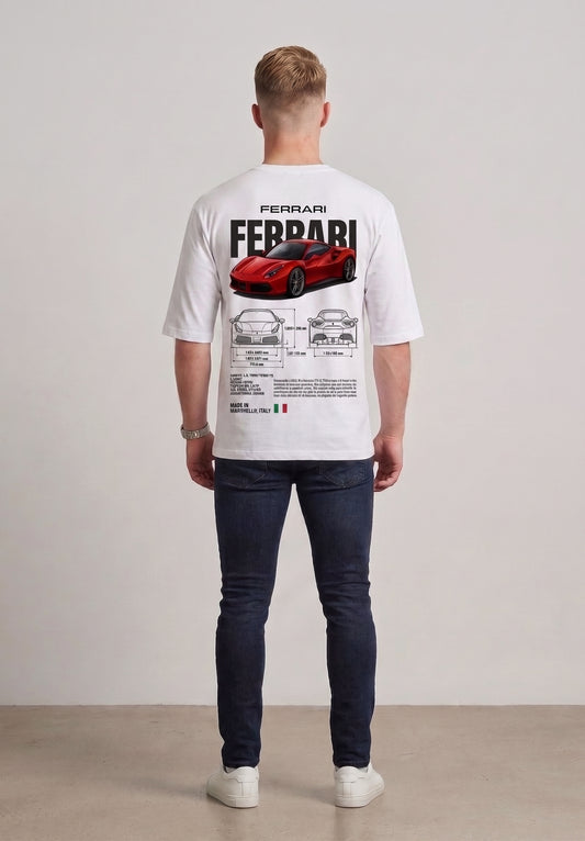 A man viewed from behind wearing a white drop shoulder t-shirt with a large red Ferrari graphic and technical blueprint print on the back, paired with dark blue jeans and white sneakers l AH Urban Wear