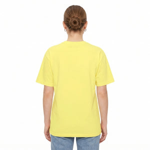 A person viewed from the back wearing a plain drop shoulder yellow T-shirt and light blue jeans against a clean white studio background l AH Urban Wear