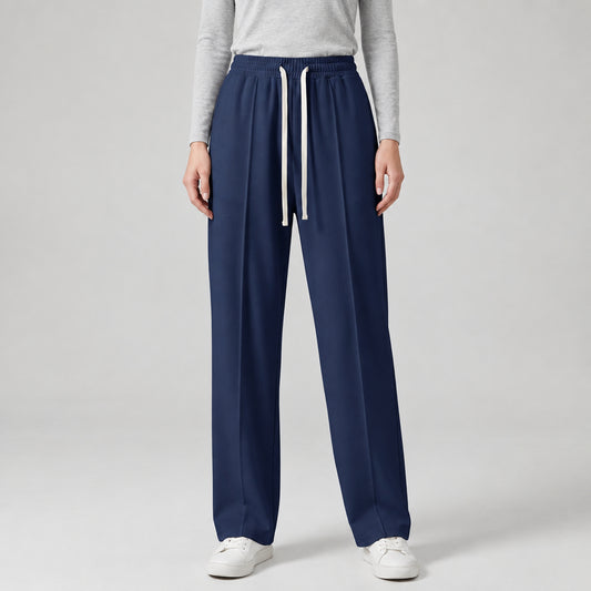 A model is wearing navy blue baggy trouser with white sneakers, shown from the waist down against a light gray studio background l AH Urban Wear